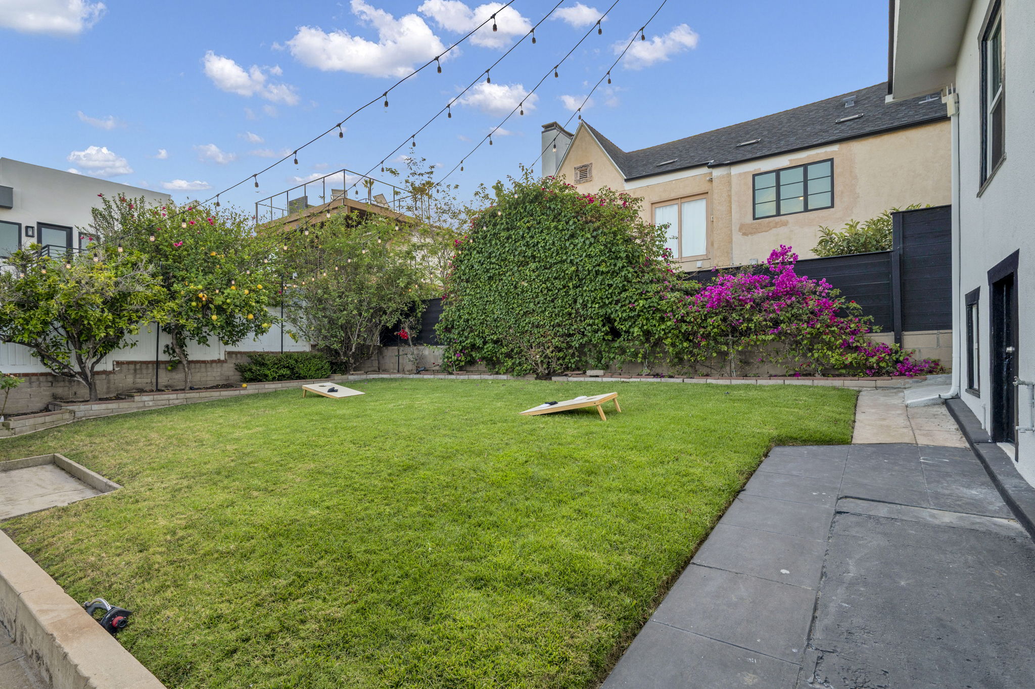 3235 Fenelon St. — Cornhole, string lights, and a detached garage.