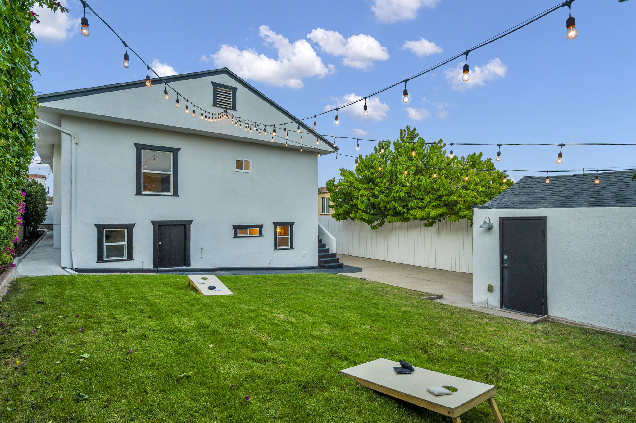 3235 Fenelon St. — Cornhole, string lights, and a detached garage.