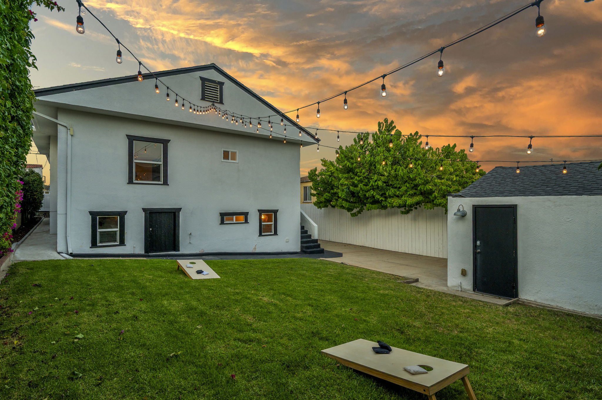 3235 Fenelon St. — Cornhole, string lights, and a detached garage.