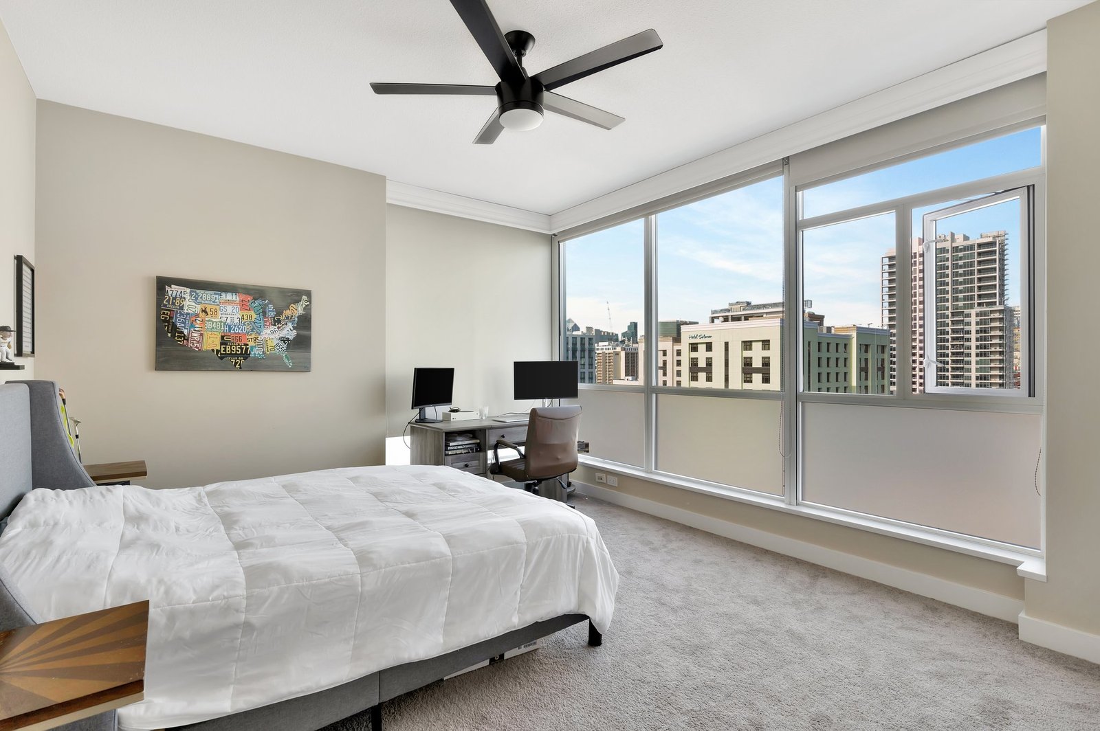 325 7th Ave., #808 — primary bedroom with city view and desk