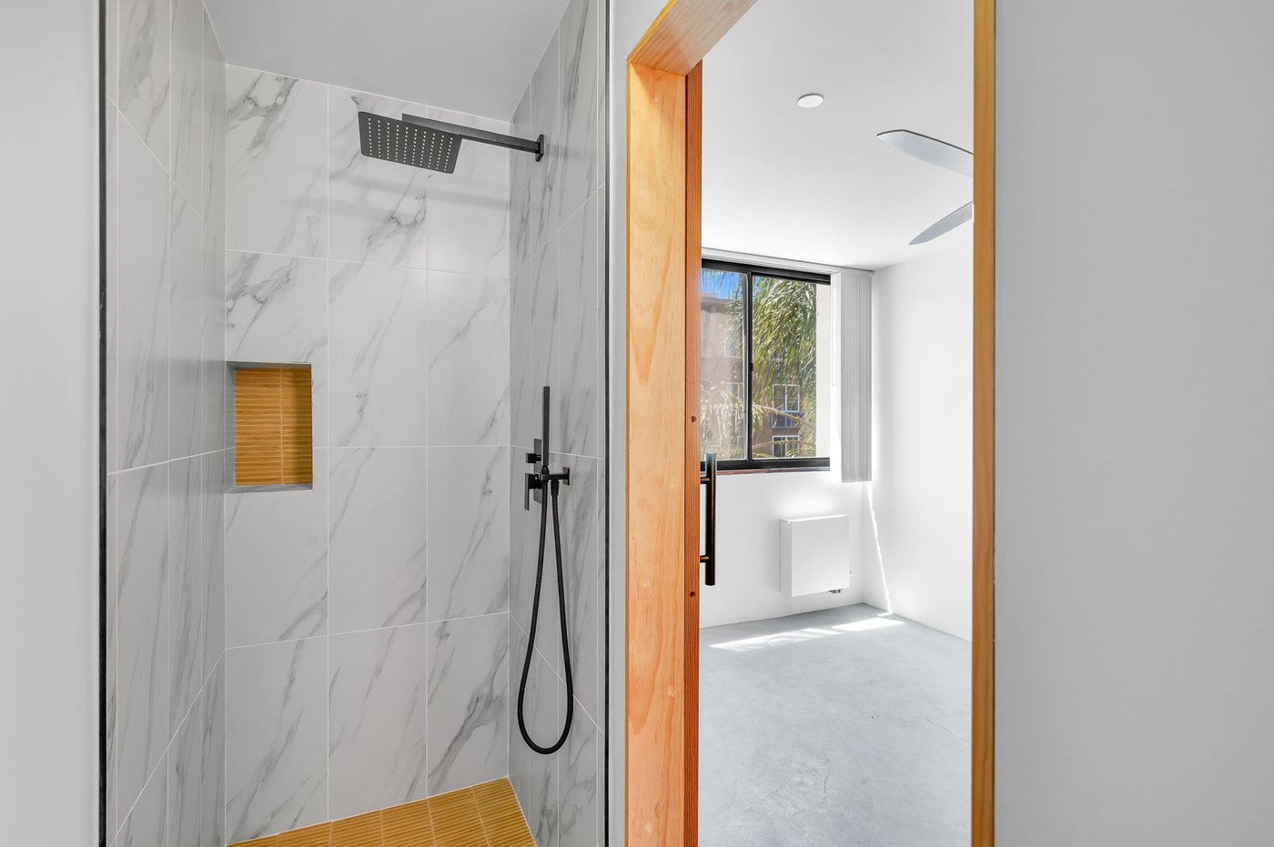 The Columbian — marble-tiled walk-in shower
